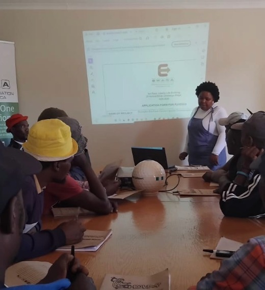E-waste dismantling trainees listening to course facilitator.